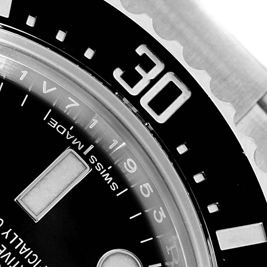 The image shows a close-up of the bezel and part of the dial of the Rolex Sea-Dweller 116600 Men's Stainless Steel Black Dial 116600 Men's Stainless Steel Black Dial watch, highlighting the 30-minute mark.