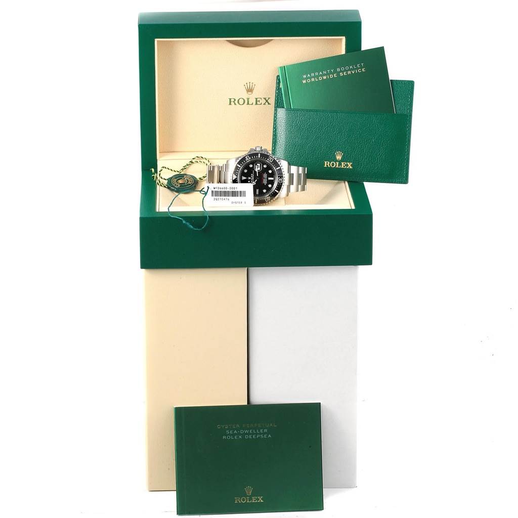 The image shows a Rolex Sea-Dweller 126600 Men's Stainless Steel Black Dial 126600 Men's Stainless Steel Black Dial watch from a front angle, with its box, warranty booklet, and product tags.