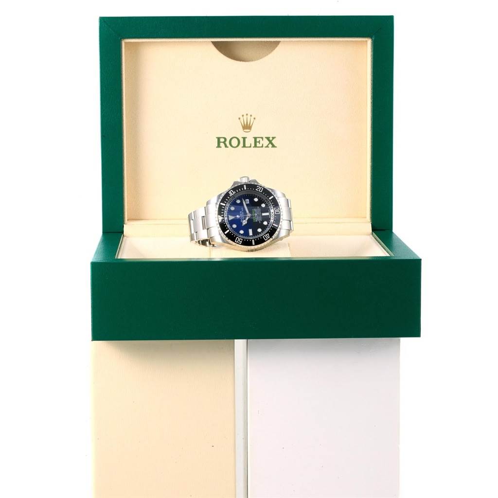 The Rolex Sea-Dweller 116660 Men's Stainless Steel Blue Dial 116660 Men's Stainless Steel Blue Dial watch is shown from the front angle in its open green and cream presentation box.