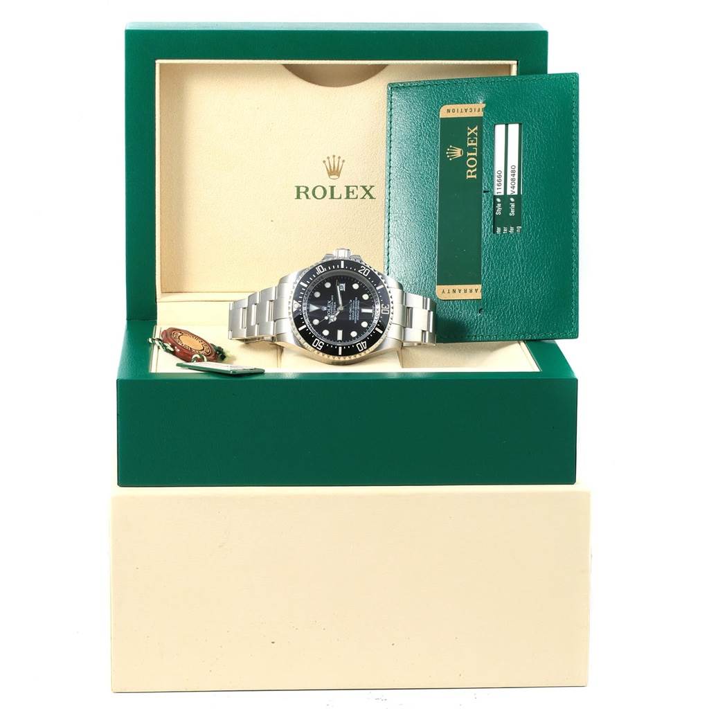 The Rolex Sea-Dweller 116660 Men's Stainless Steel Black Dial 116660 Men's Stainless Steel Black Dial watch is displayed front and center with its box, warranty card, and tag.