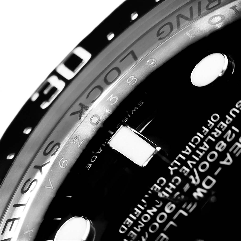 This close-up image of the Rolex Sea-Dweller 116660 Men's Stainless Steel Black Dial 116660 Men's Stainless Steel Black Dial watch shows part of the bezel, dial, and the "RING LOCK SYSTEM" inscription.