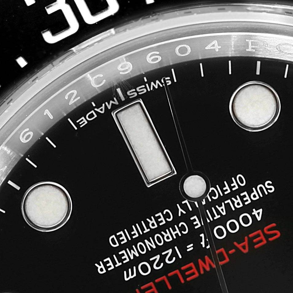 The image shows a close-up of the dial of a Rolex Sea-Dweller 126600 Men
s Stainless Steel Black Dial 126600 Men
s Stainless Steel Black Dial watch, focusing on the markers and text.