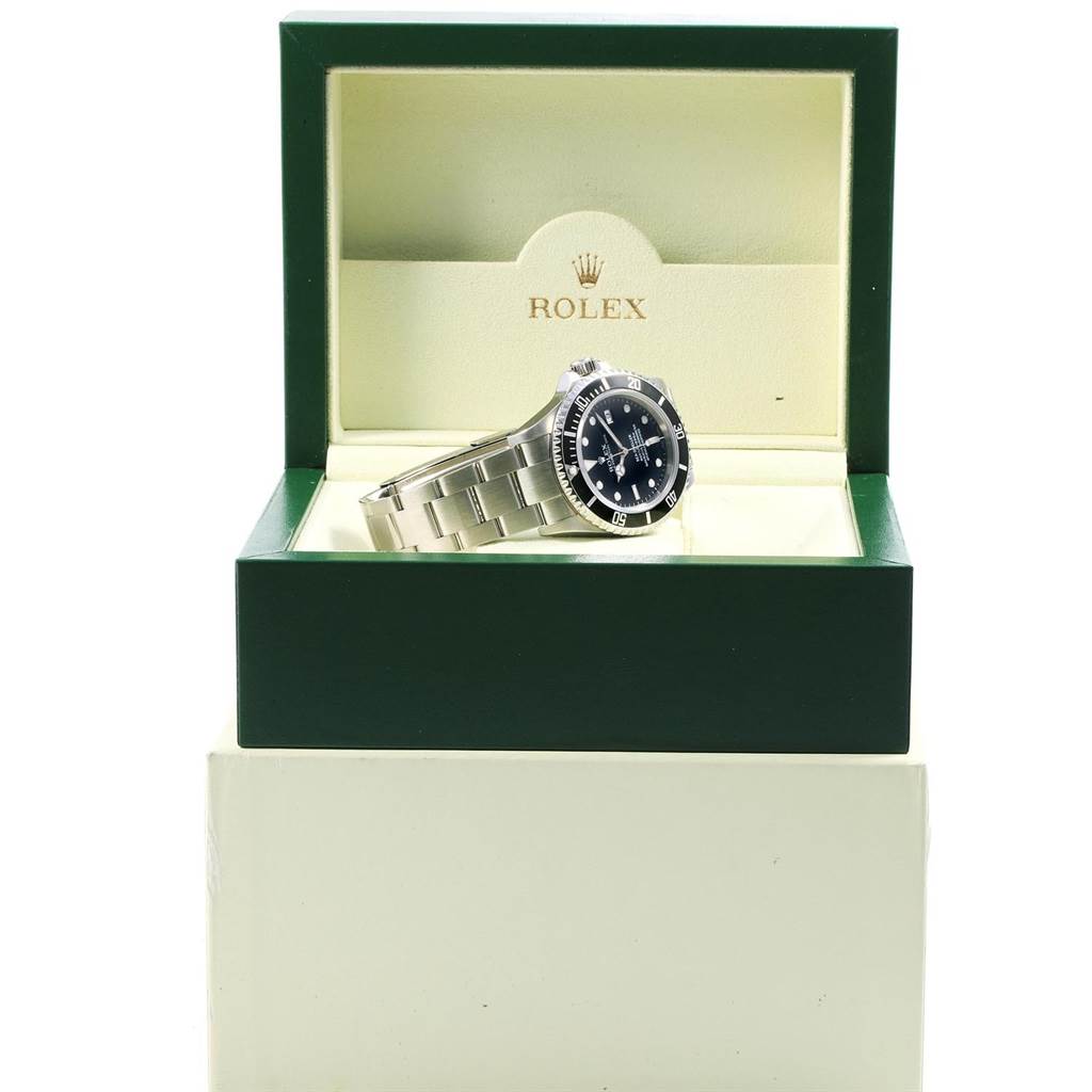 The Rolex Sea-Dweller 16600 Men
s Stainless Steel Black Dial 16600 Men
s Stainless Steel Black Dial watch is shown at an angle inside an open case, highlighting the black dial, rotating bezel, and metal bracelet.