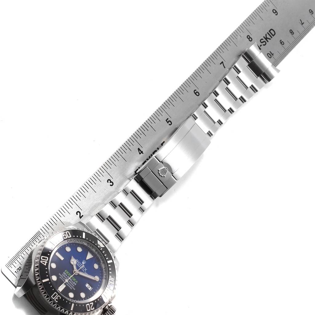 The image shows a Rolex Sea-Dweller 116660 Men's Stainless Steel Blue Dial 116660 Men's Stainless Steel Blue Dial watch laid flat next to a ruler, highlighting its bracelet, clasp, and bezel.