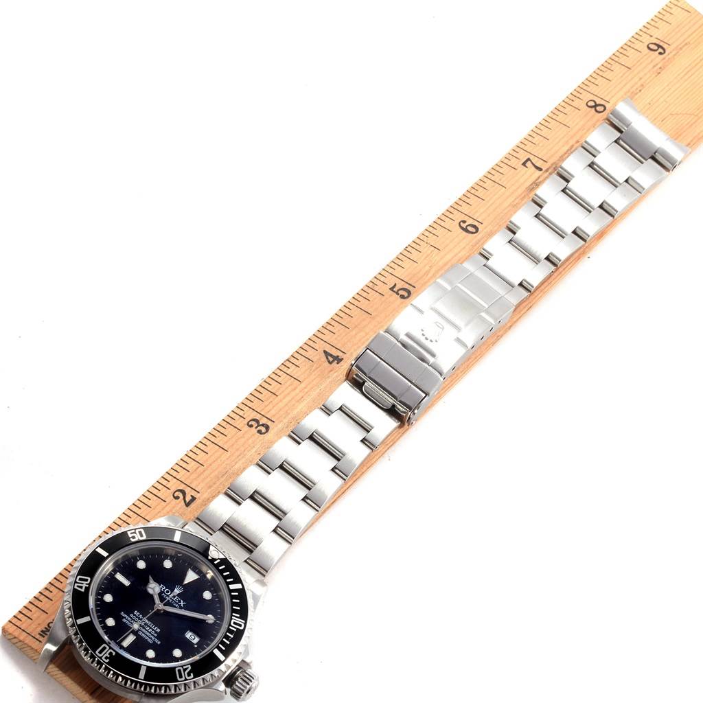 The Rolex Sea-Dweller 16600 Men
s Stainless Steel Black Dial 16600 Men
s Stainless Steel Black Dial watch is shown lying flat, with the face, bezel, bracelet, and clasp visible alongside a ruler for scale.
