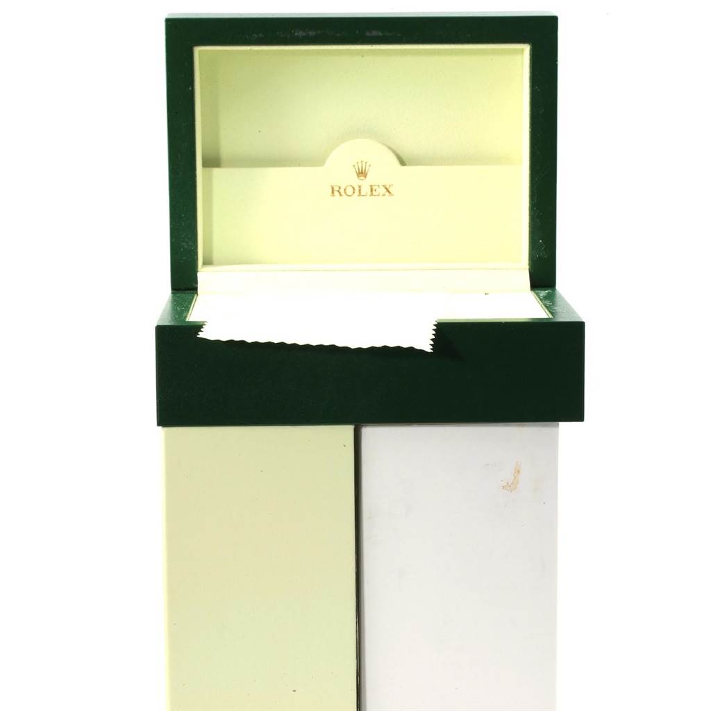 The image shows an open green Rolex watch box, likely for the Sea-Dweller model, with a cleaning cloth inside.