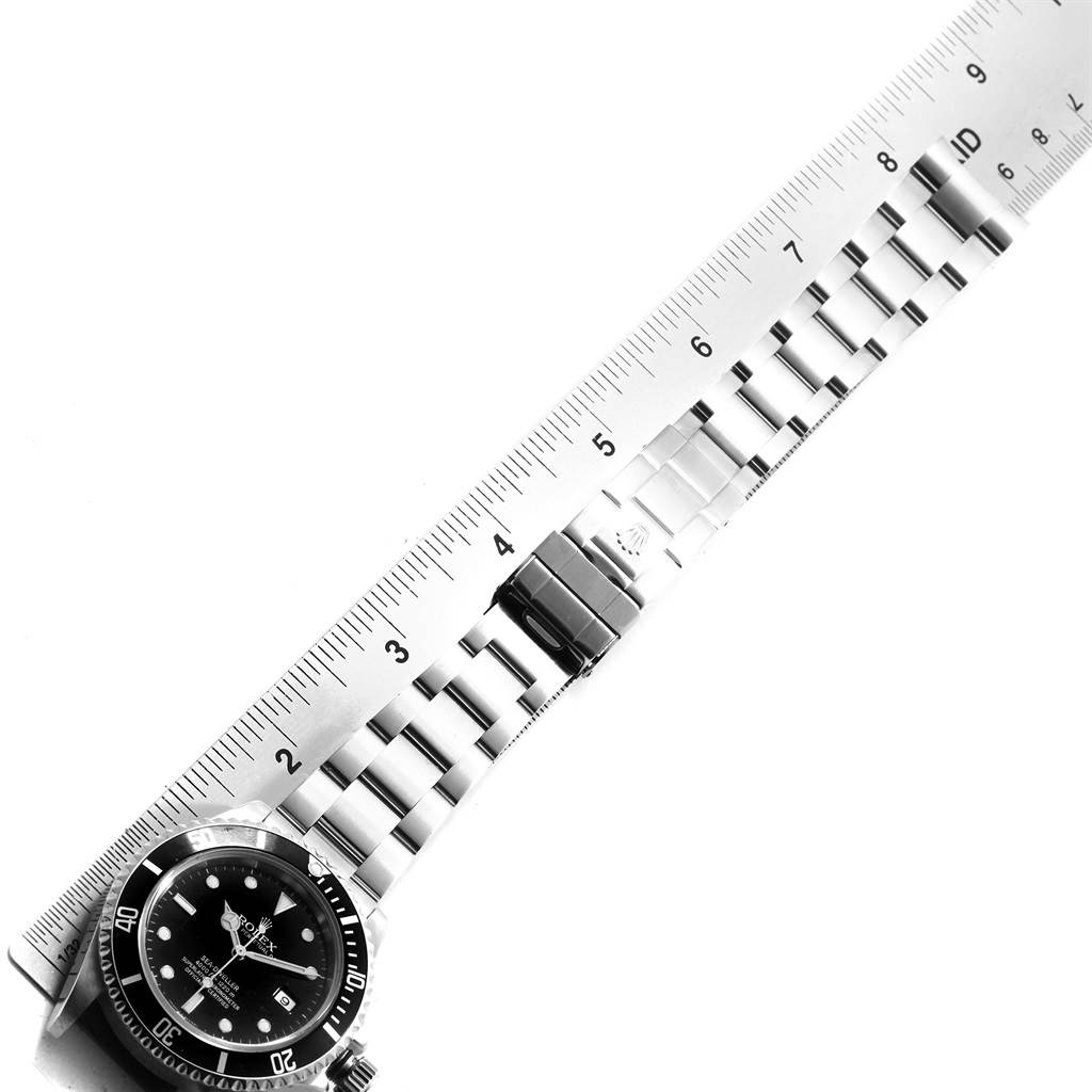 The image shows the Rolex Sea-Dweller 16600 Men
s Stainless Steel Black Dial 16600 Men
s Stainless Steel Black Dial watch laid flat with its metal bracelet measured against a ruler.