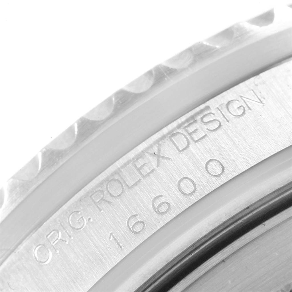 This close-up image shows the bezel and case edge of a Rolex Sea-Dweller 16600 Men
s Stainless Steel Black Dial 16600 Men
s Stainless Steel Black Dial model, displaying "ROLEX DESIGN" and the model number "16600".