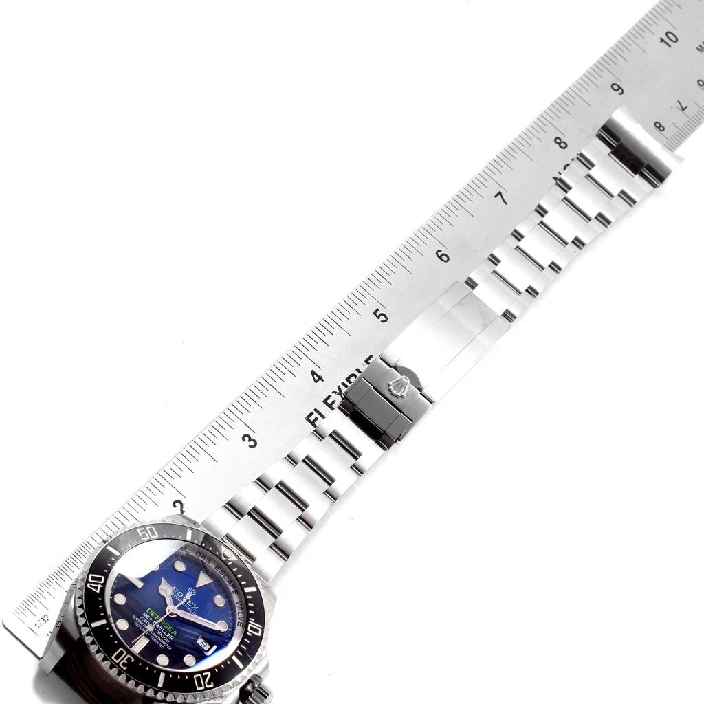 The image shows the face and metal bracelet of a Rolex Sea-Dweller 116660 Men
s Stainless Steel Blue Dial 116660 Men
s Stainless Steel Blue Dial watch, laid next to a ruler for measurement.