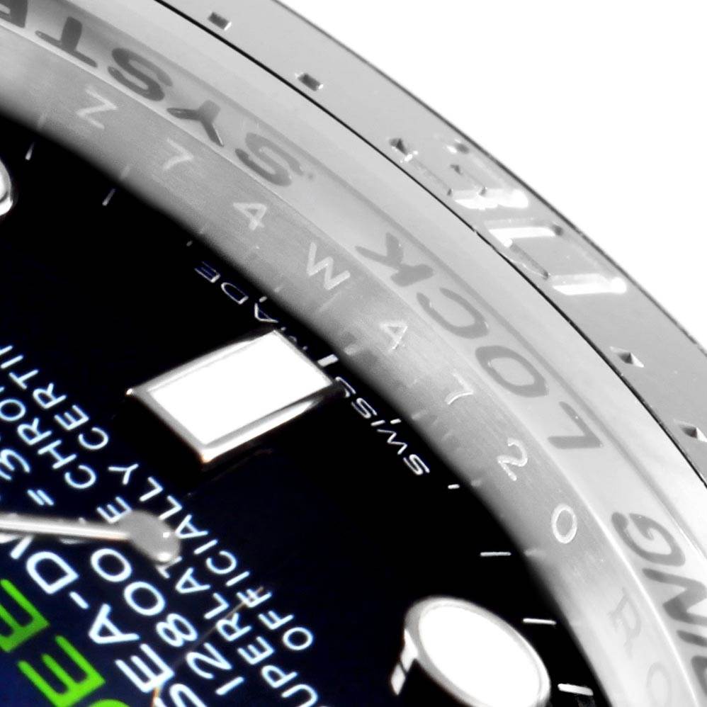 This close-up angle of the Rolex Sea-Dweller 116660 Men
s Stainless Steel Blue Dial 116660 Men
s Stainless Steel Blue Dial watch displays part of the bezel and a section of the dial with text.