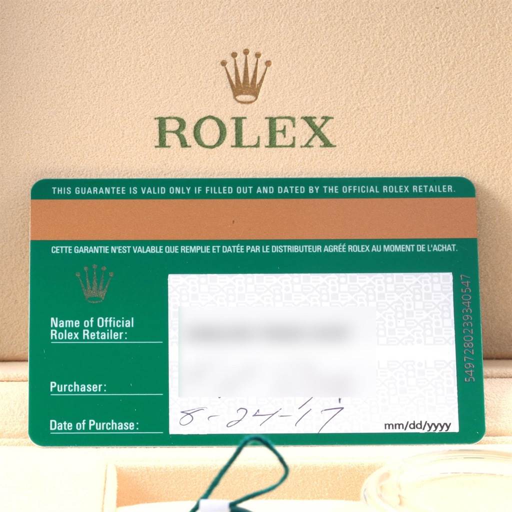 The image shows a warranty card for a Sea-Dweller model by Rolex, with the brand name visible in the background.