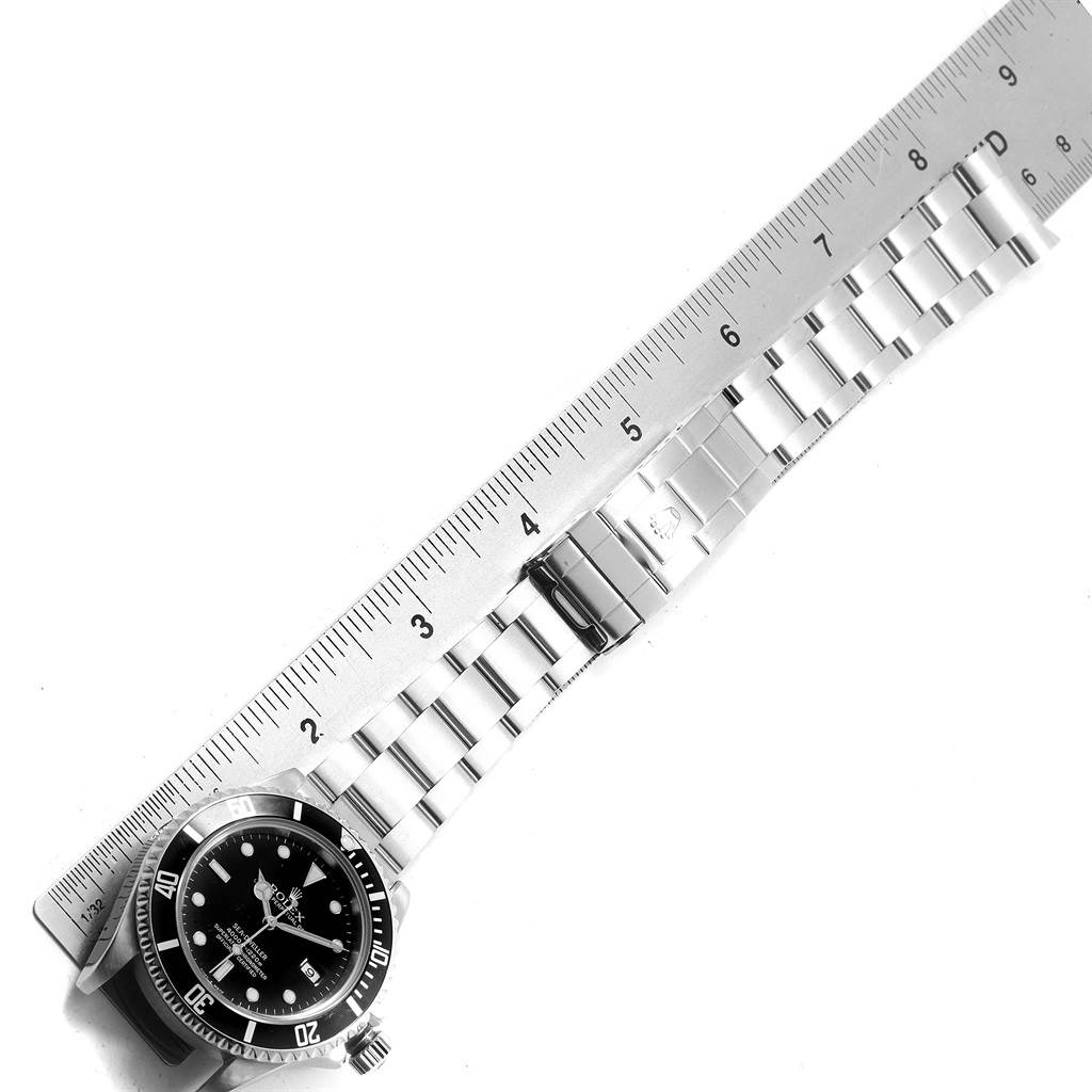 The image shows a top-down view of a Rolex Sea-Dweller 16600 Men
s Stainless Steel Black Dial 16600 Men
s Stainless Steel Black Dial watch with a visible measuring tape along the bracelet.