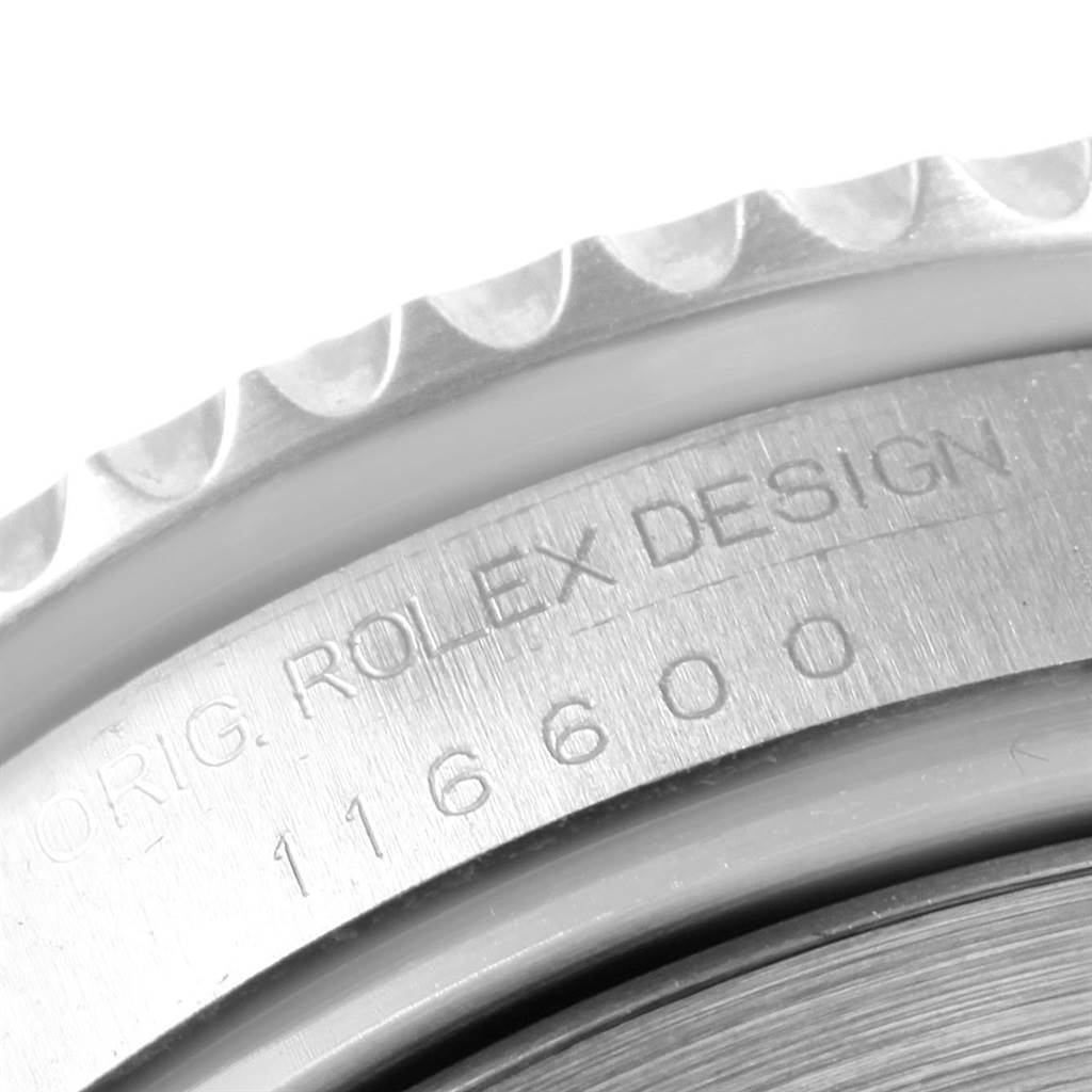 The image shows a close-up of the bezel and engraved serial number on the case of a Rolex Sea-Dweller 116600 Men
s Stainless Steel Black Dial 116600 Men
s Stainless Steel Black Dial watch.
