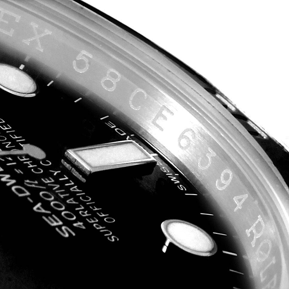 This close-up image shows the dial and part of the bezel of a Rolex Sea-Dweller 116600 Men
s Stainless Steel Black Dial 116600 Men
s Stainless Steel Black Dial watch.