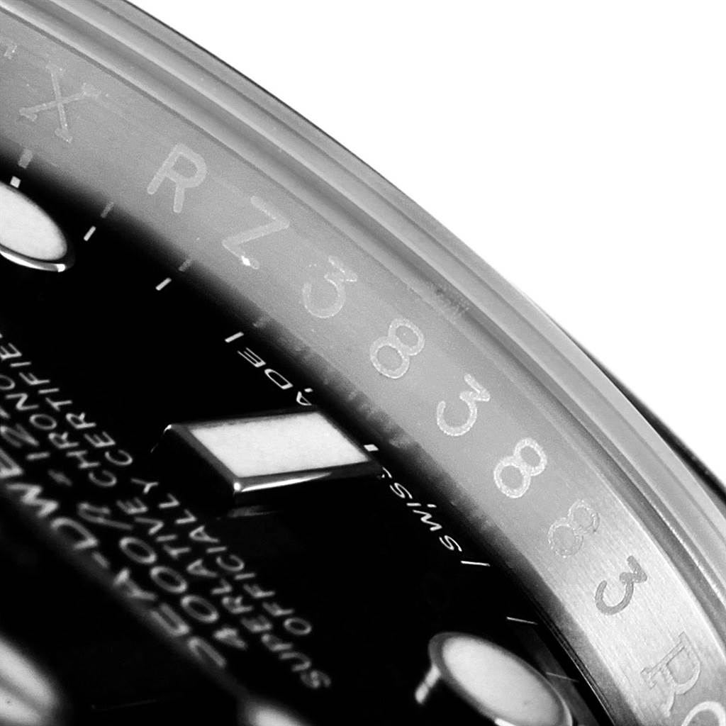 The image shows a close-up of the Rolex Sea-Dweller 116600 Men
s Stainless Steel Black Dial 116600 Men
s Stainless Steel Black Dial watch
s dial and the inner bezel with engraved numbers.