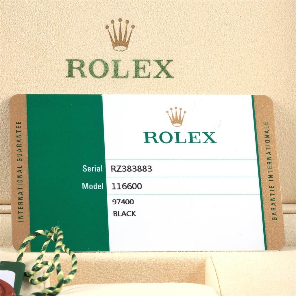 The image shows a warranty card for the Rolex Sea-Dweller 116600 Men
s Stainless Steel Black Dial 116600 Men
s Stainless Steel Black Dial model 116600, placed inside a Rolex box.