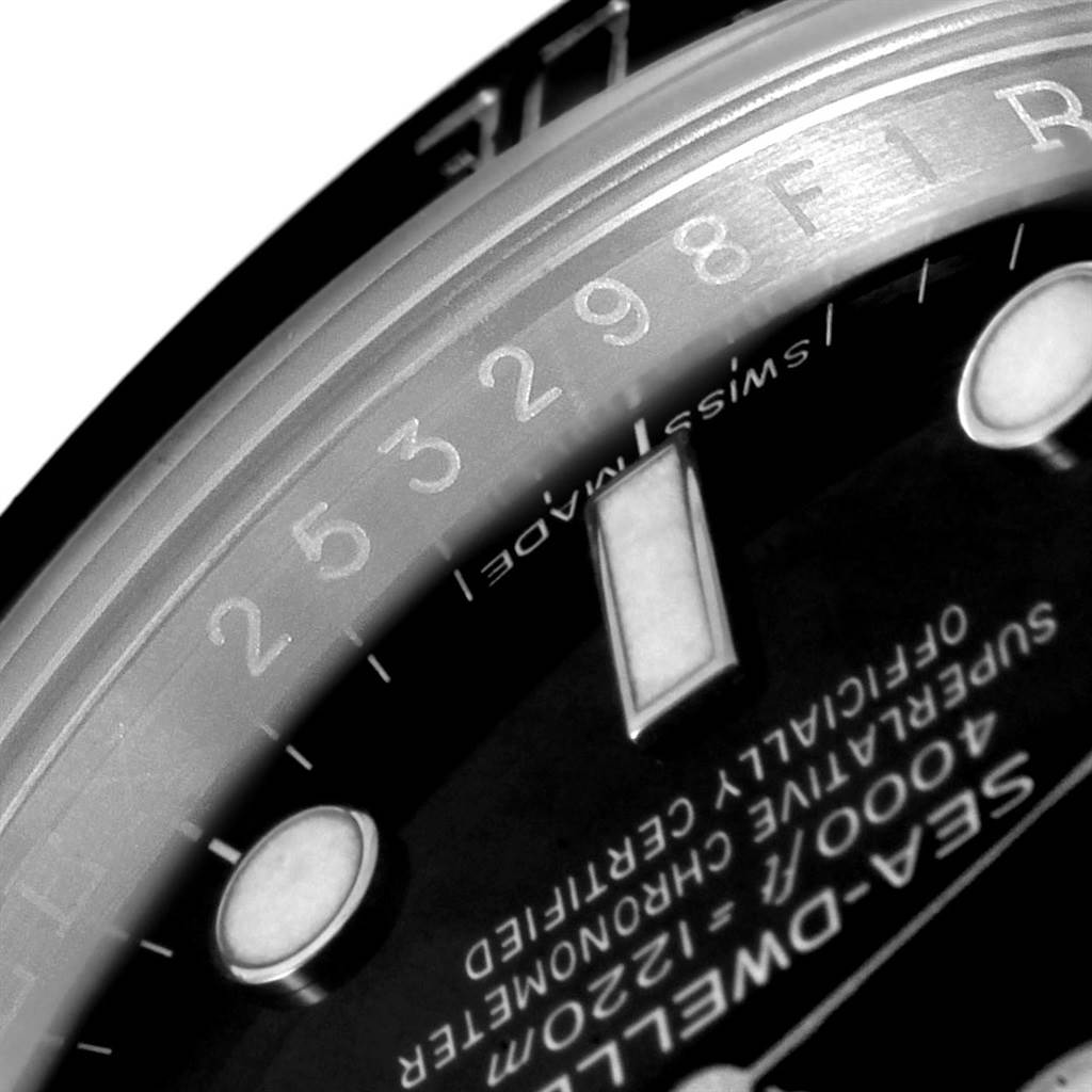 The image shows a close-up angle of the dial and bezel edge of the Rolex Sea-Dweller 116600 Men
s Stainless Steel Black Dial 116600 Men
s Stainless Steel Black Dial watch, focusing on the text and hour markers.