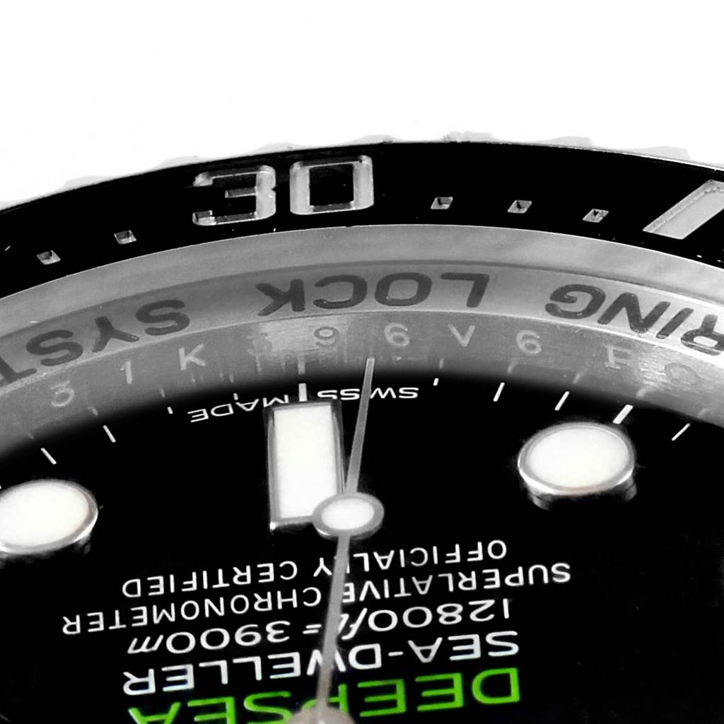 The image shows a close-up of the dial and bezel of a Rolex Sea-Dweller 116660 Men
s Stainless Steel Blue Dial 116660 Men
s Stainless Steel Blue Dial watch, focusing on the branding and some numeric markers.