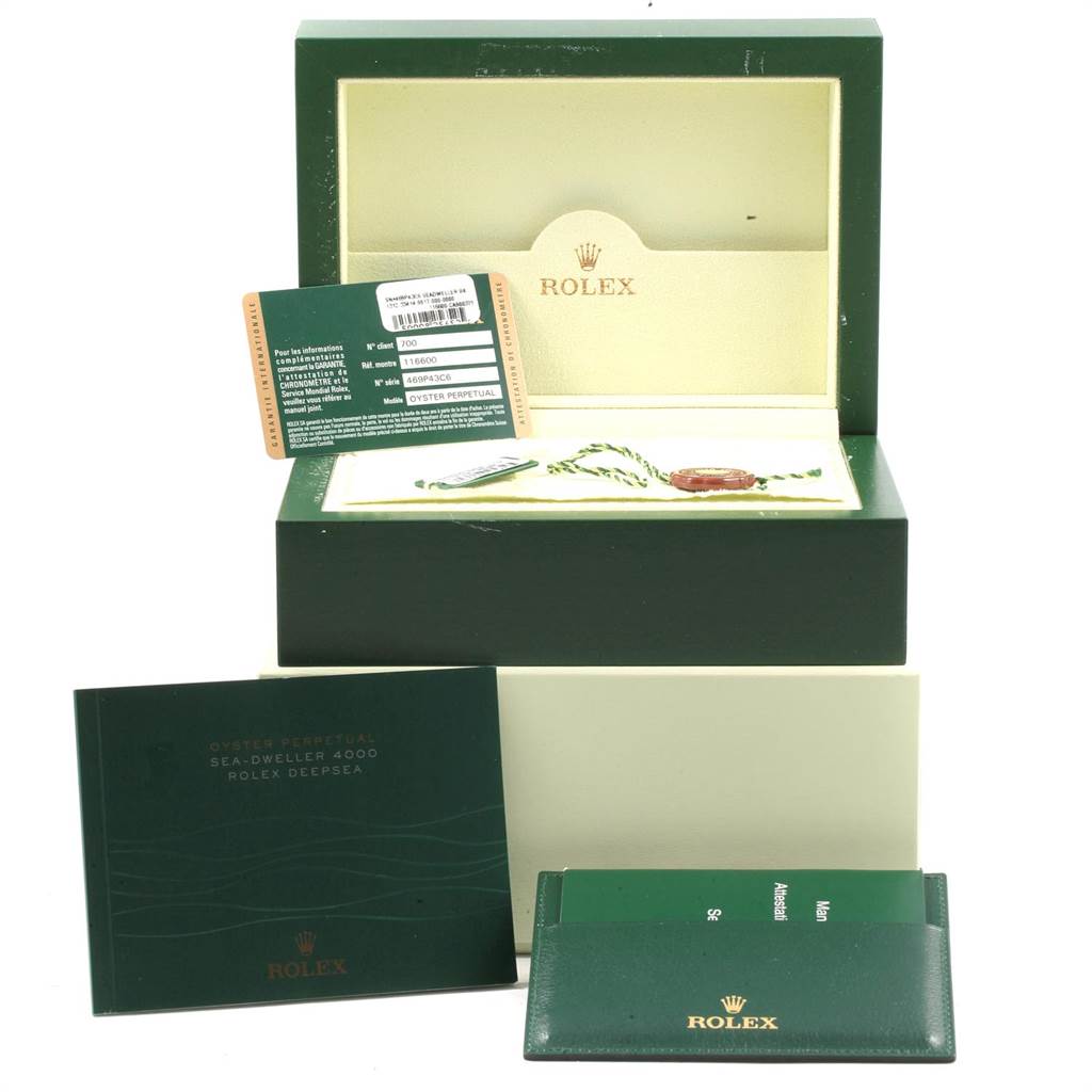 The image shows a Rolex Sea-Dweller 116600 Men
s Stainless Steel Black Dial 116600 Men
s Stainless Steel Black Dial watch box, warranty card, manuals, and tags from a frontal angle.