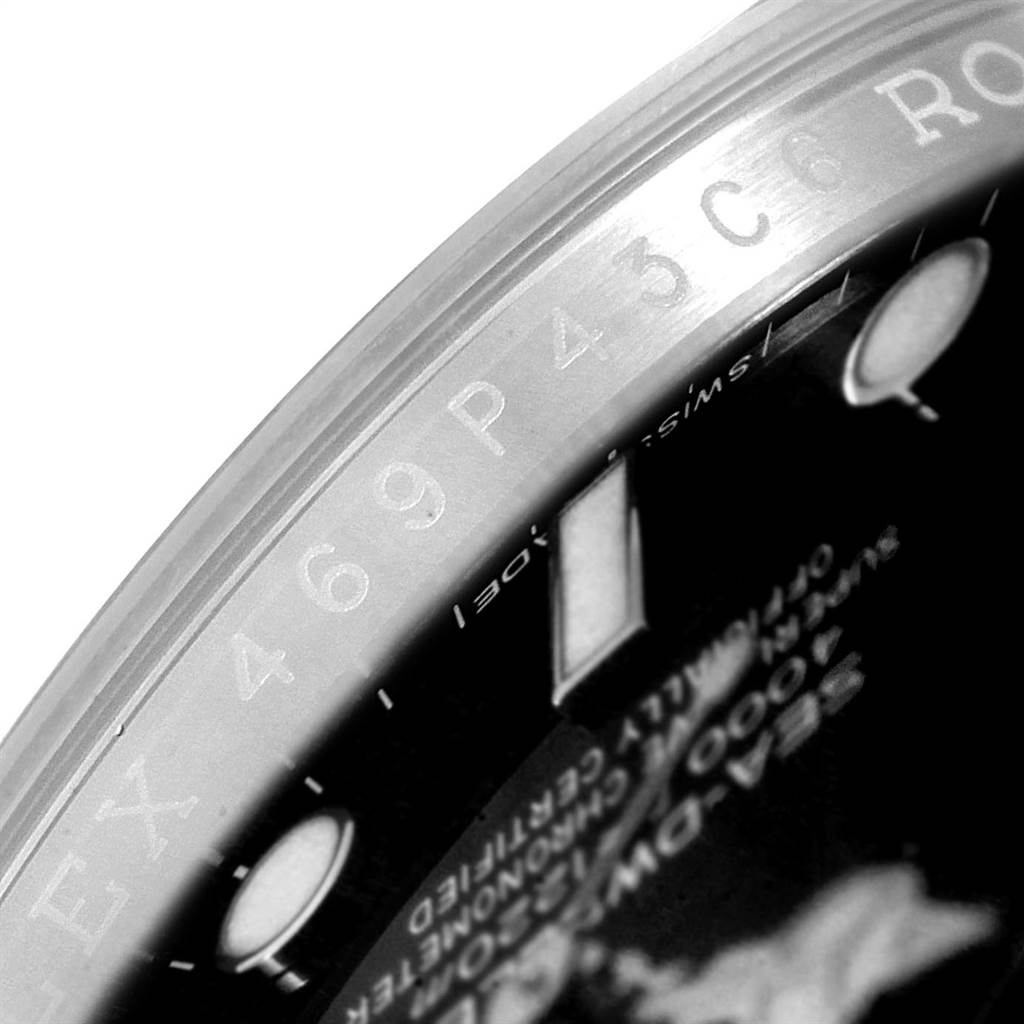 This close-up shot of the Rolex Sea-Dweller 116600 Men
s Stainless Steel Black Dial 116600 Men
s Stainless Steel Black Dial shows the outer bezel edge and part of the dial with text.