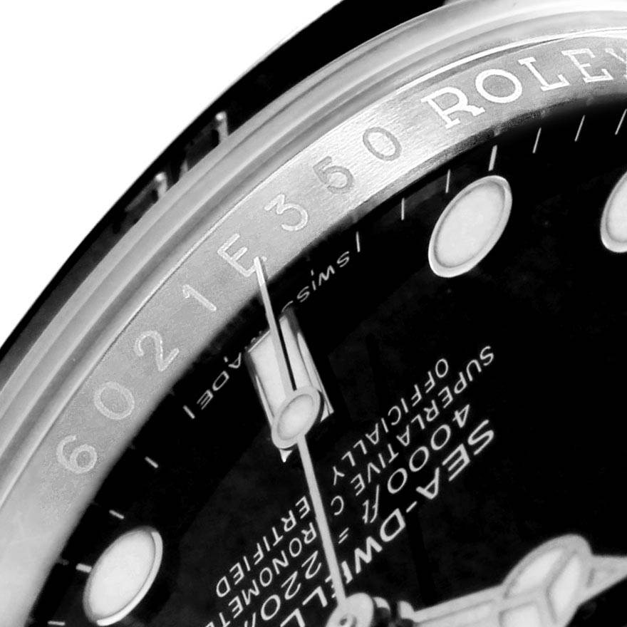 This close-up angle of the Rolex Sea-Dweller 116600 Men
s Stainless Steel Black Dial 116600 Men
s Stainless Steel Black Dial watch shows part of the dial and the engraved bezel.