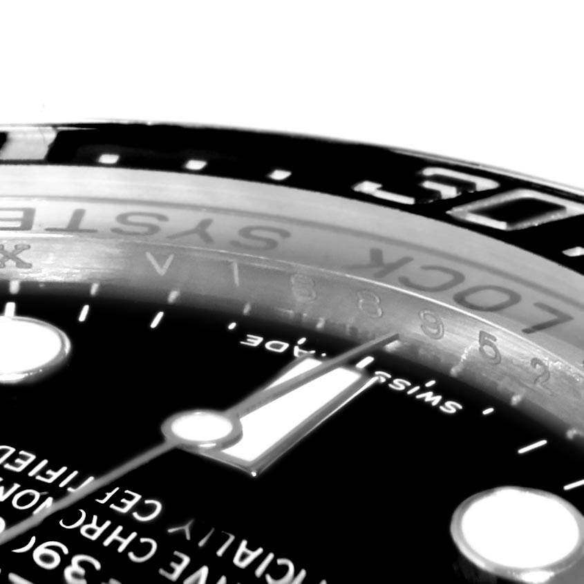 The image shows a close-up of the dial and bezel of a Rolex Sea-Dweller 116660 Men
s Stainless Steel Black Dial 116660 Men
s Stainless Steel Black Dial, taken from an oblique angle.