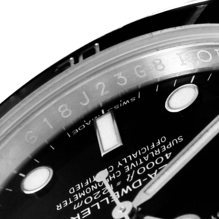 The image shows a close-up angle of the bezel and part of the dial of a Rolex Sea-Dweller 116600 Men
s Stainless Steel Black Dial 116600 Men
s Stainless Steel Black Dial watch.