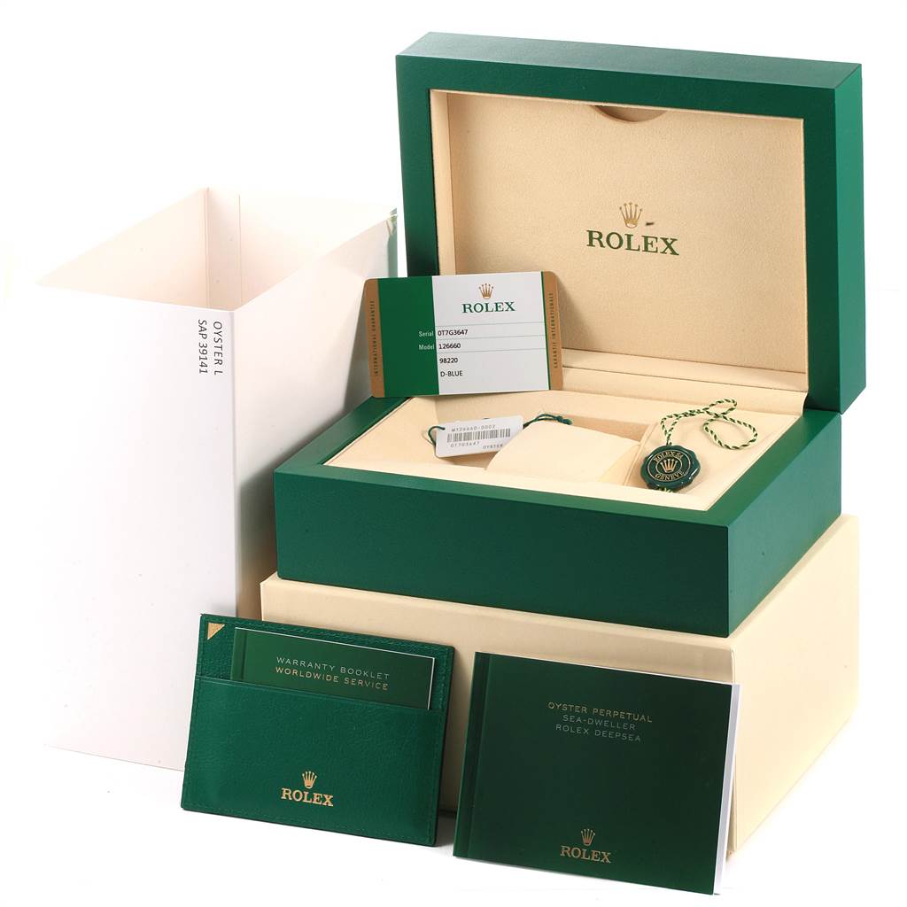 The image shows the packaging and accessories for a Rolex Sea-Dweller 126660 Men
s Stainless Steel Blue Dial 126660 Men
s Stainless Steel Blue Dial watch, including booklets, a certificate, and a green box.