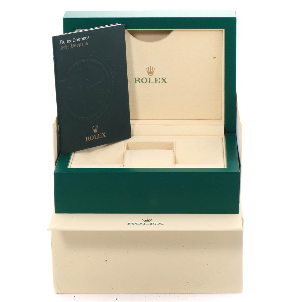 The image shows the box and a booklet for a Rolex Sea-Dweller 116660 Men
s Stainless Steel Black Dial 116660 Men
s Stainless Steel Black Dial watch, photographed from the front.