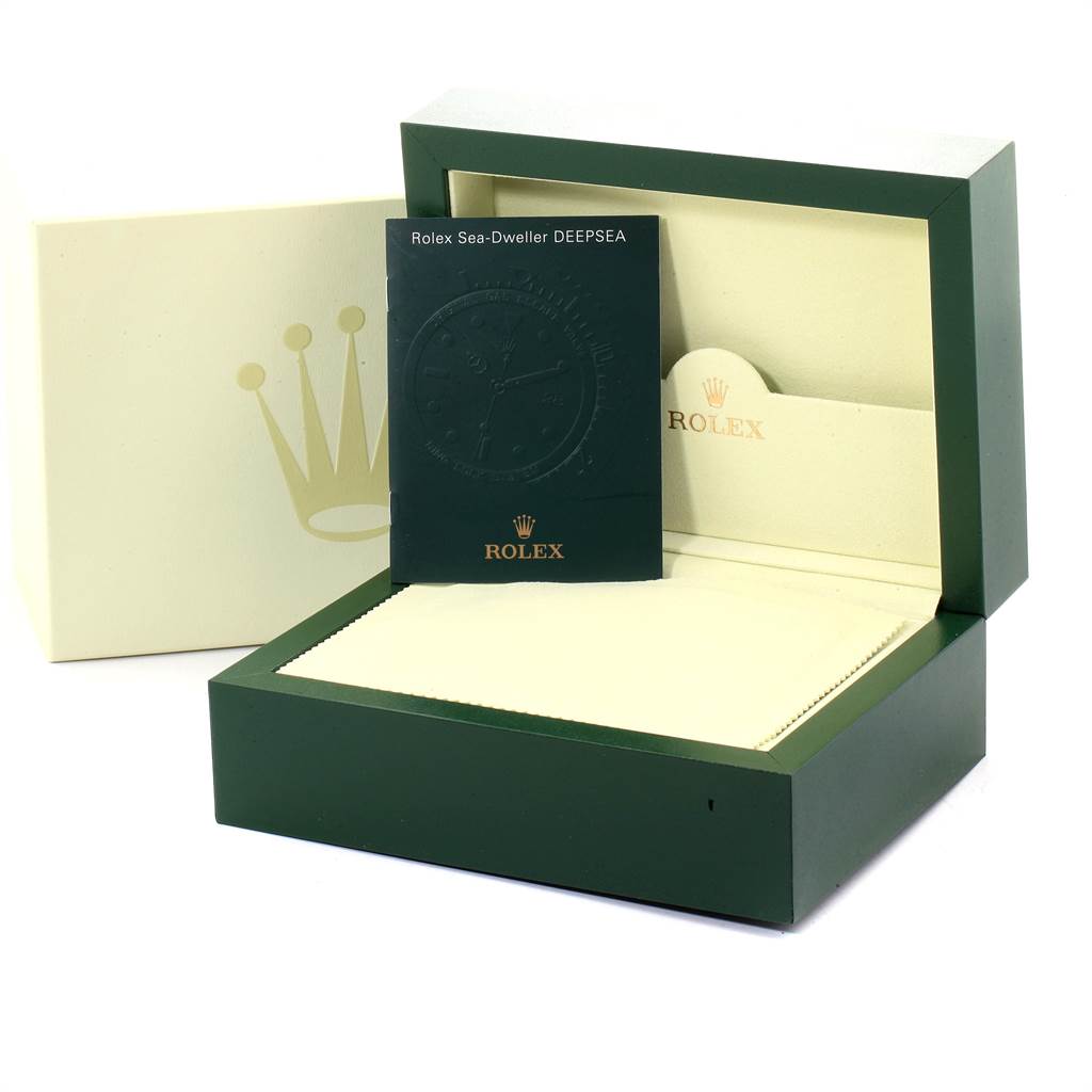 The image shows the packaging and manual for the Rolex Sea-Dweller 116660 Men's Stainless Steel Blue Dial 116660 Men's Stainless Steel Blue Dial watch, including the outer box, inner box, and green booklet.