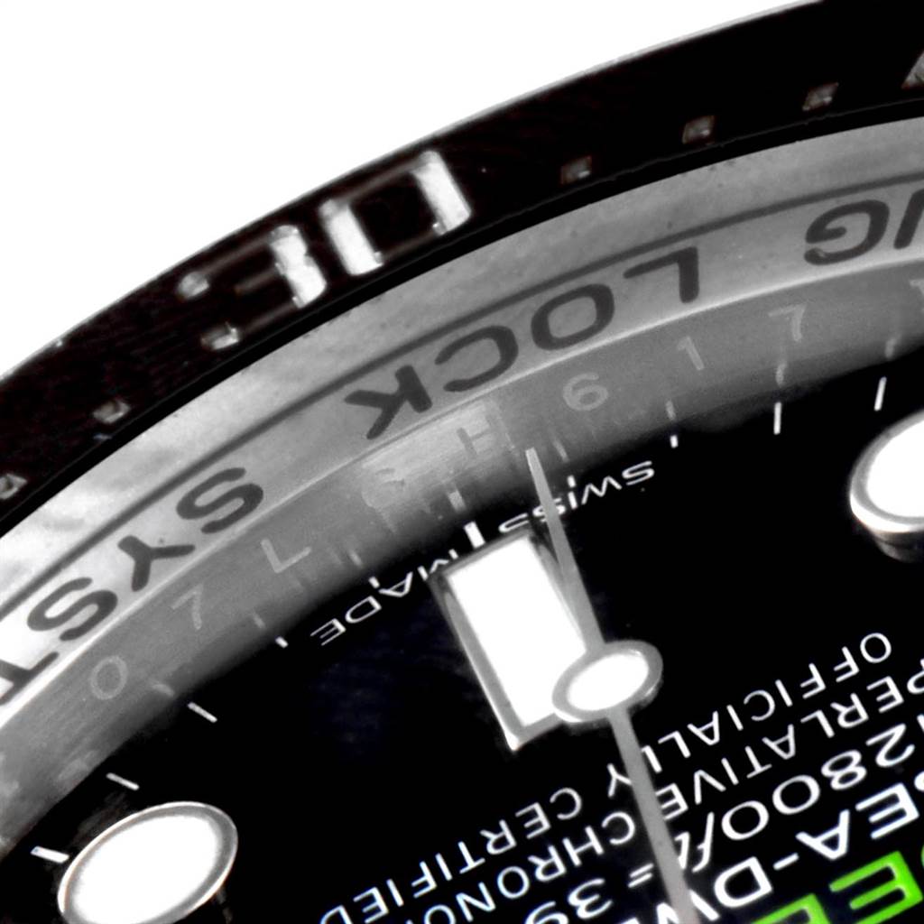 This close-up image of the Rolex Sea-Dweller 116660 Men's Stainless Steel Blue Dial 116660 Men's Stainless Steel Blue Dial watch shows part of the bezel and dial with text details.