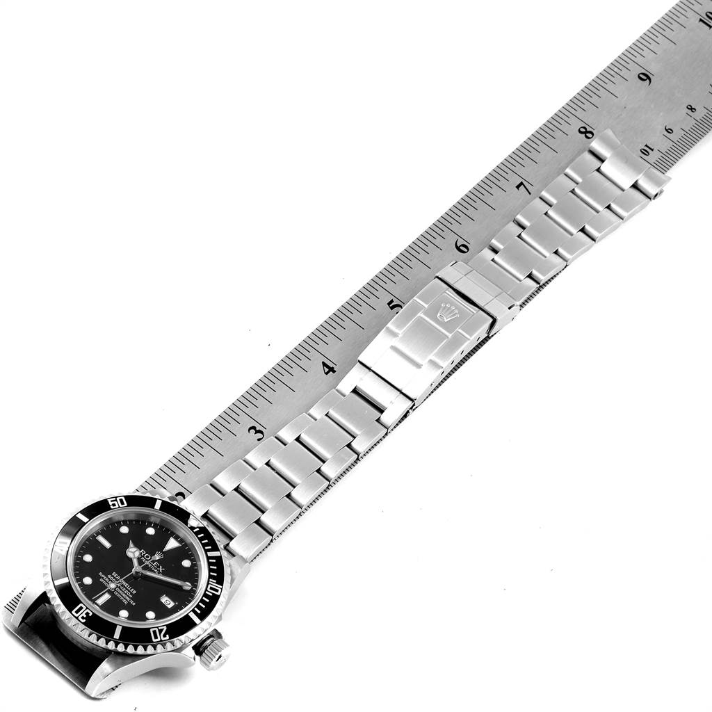 The Rolex Sea-Dweller 16600 Men
s Stainless Steel Black Dial 16600 Men
s Stainless Steel Black Dial watch is shown angled slightly to the side, with a ruler measuring its stainless steel bracelet.