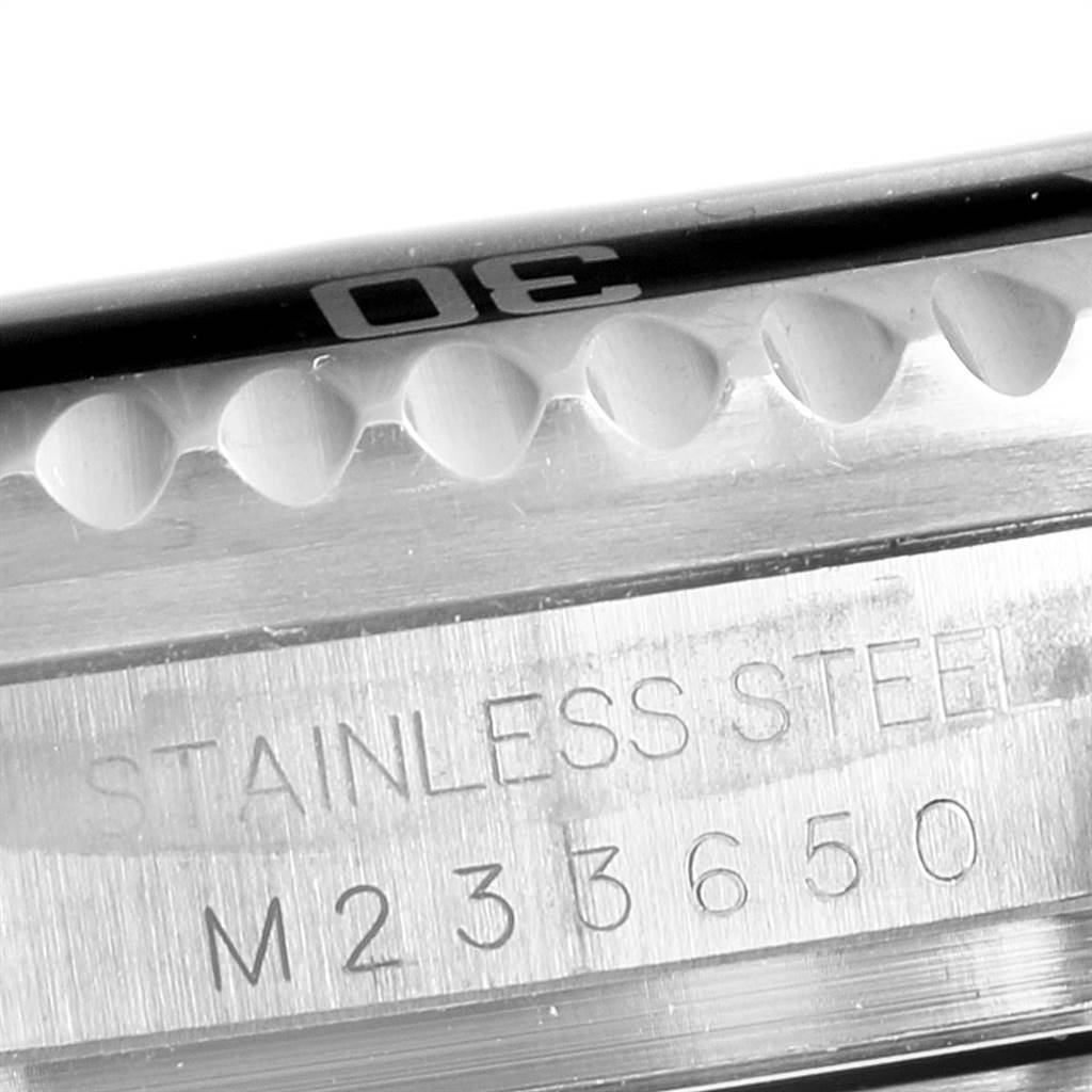 This image shows a close-up of the bezel and the stainless steel case back of a Rolex Sea-Dweller 16600 Men
s Stainless Steel Black Dial 16600 Men
s Stainless Steel Black Dial watch with some engraved markings.