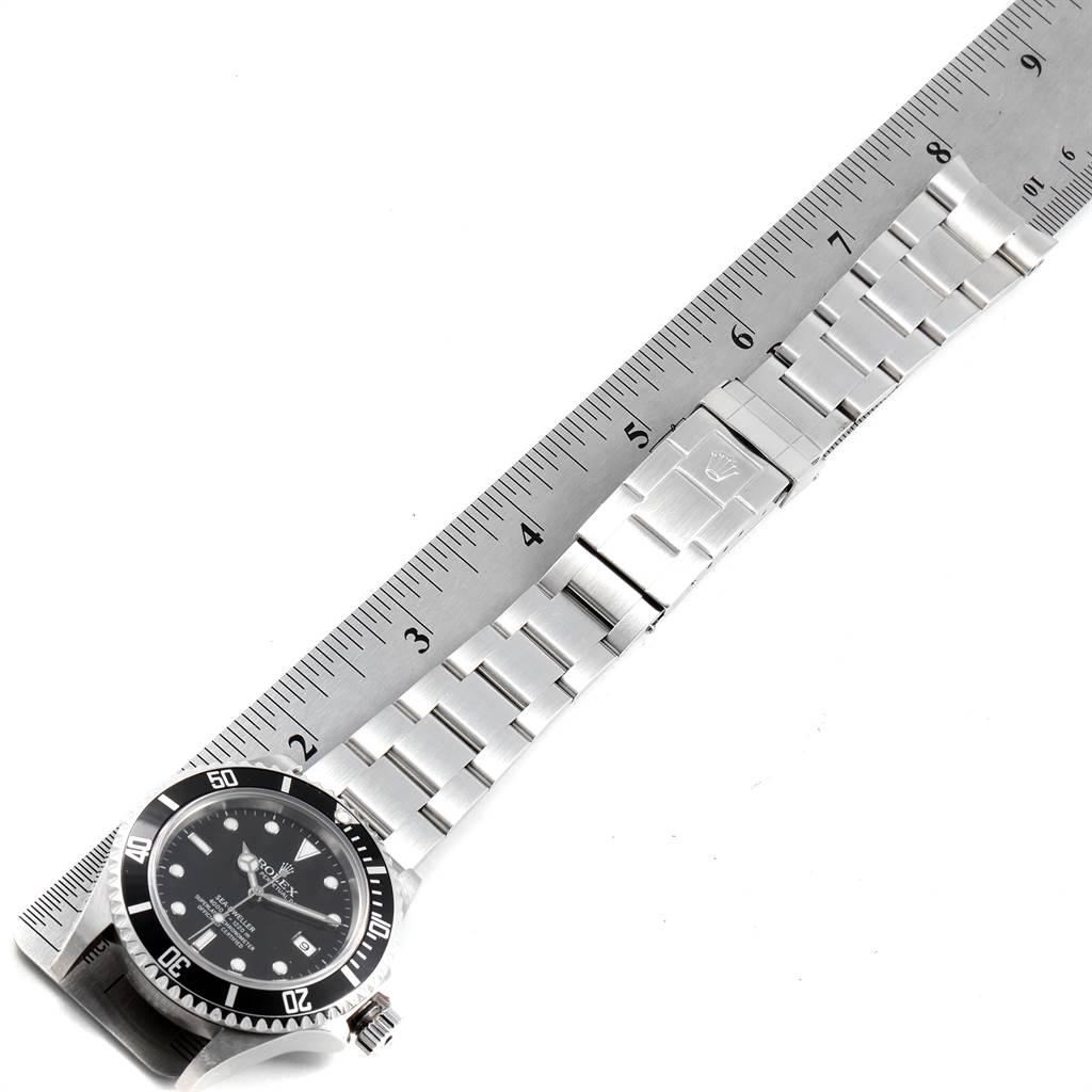 The image shows the Rolex Sea-Dweller 16600 Men
s Stainless Steel Black Dial 16600 Men
s Stainless Steel Black Dial watch placed alongside a ruler, displaying the face, bezel, case, and metal bracelet.