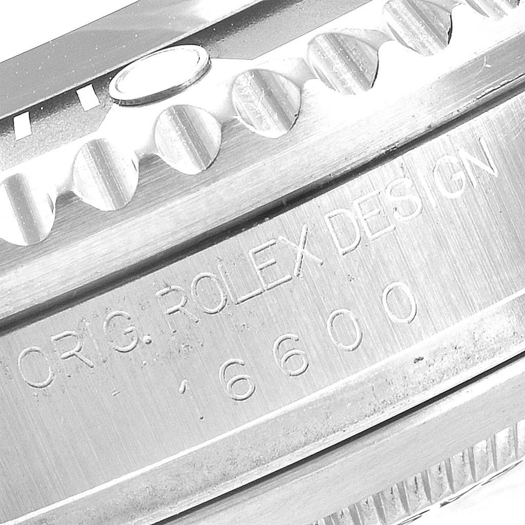The image shows a close-up of the bezel and engraved serial number on the case of a Rolex Sea-Dweller 16600 Men
s Stainless Steel Black Dial 16600 Men
s Stainless Steel Black Dial model.