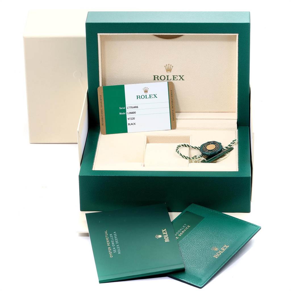 The image shows the box, warranty card, tag, and booklets for a Rolex Sea-Dweller 126600 Men
s Stainless Steel Black Dial 126600 Men
s Stainless Steel Black Dial.