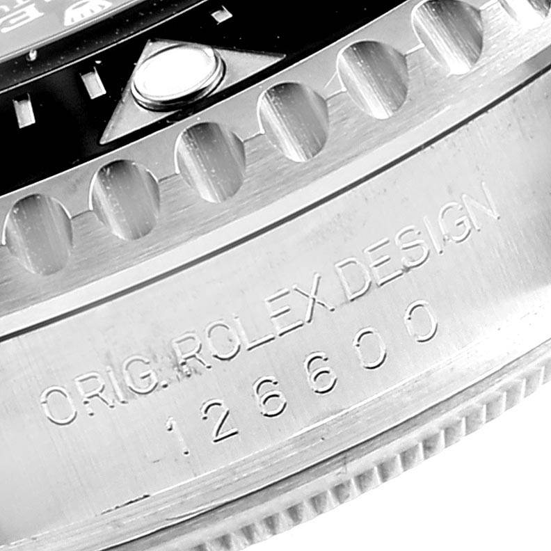 This close-up image of a Rolex Sea-Dweller 126600 Men
s Stainless Steel Black Dial 126600 Men
s Stainless Steel Black Dial watch shows the engraved side of the case and part of the bezel.