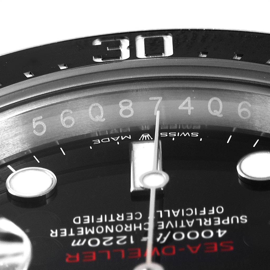 This close-up shot of the Rolex Sea-Dweller 126600 Men
s Stainless Steel Black Dial 126600 Men
s Stainless Steel Black Dial watch features the dial, bezel, and part of the hands.