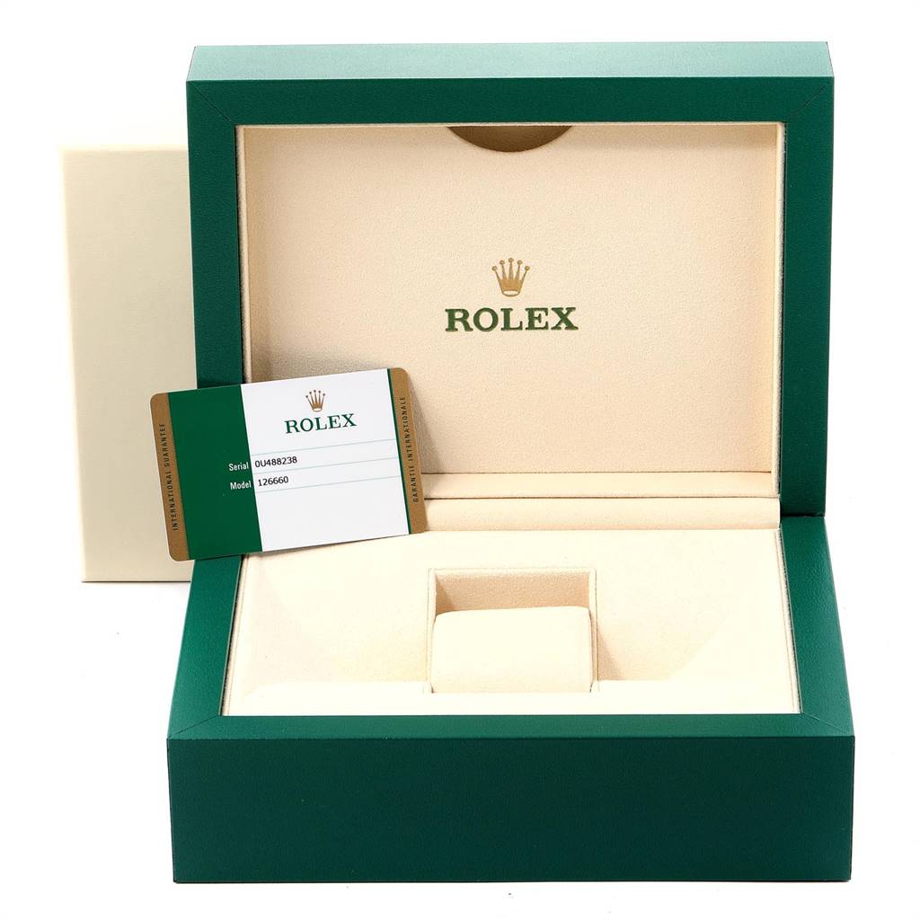 The image shows an open green Rolex box for the Sea-Dweller model, with a card displaying the model and serial number.