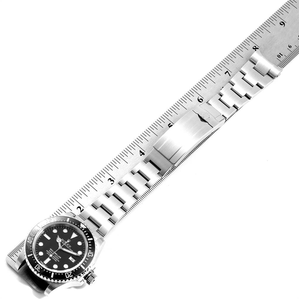 The image shows a Rolex Sea-Dweller 116600 Men
s Stainless Steel Black Dial 116600 Men
s Stainless Steel Black Dial watch lying flat, with its face and bracelet fully visible next to a measuring ruler.