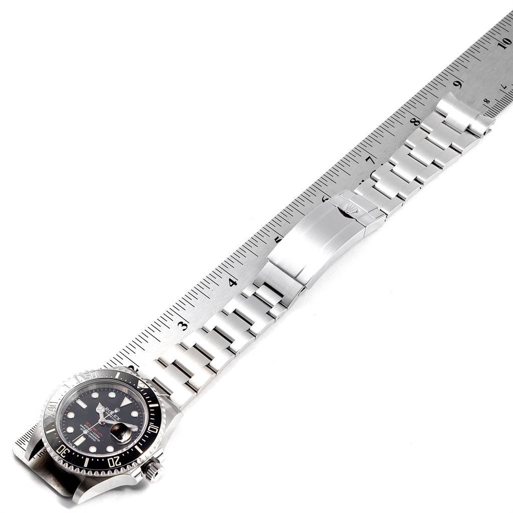 The image shows the Rolex Sea-Dweller 126600 Men
s Stainless Steel Black Dial 126600 Men
s Stainless Steel Black Dial watch laid flat and measured against a ruler with its bracelet fully extended.