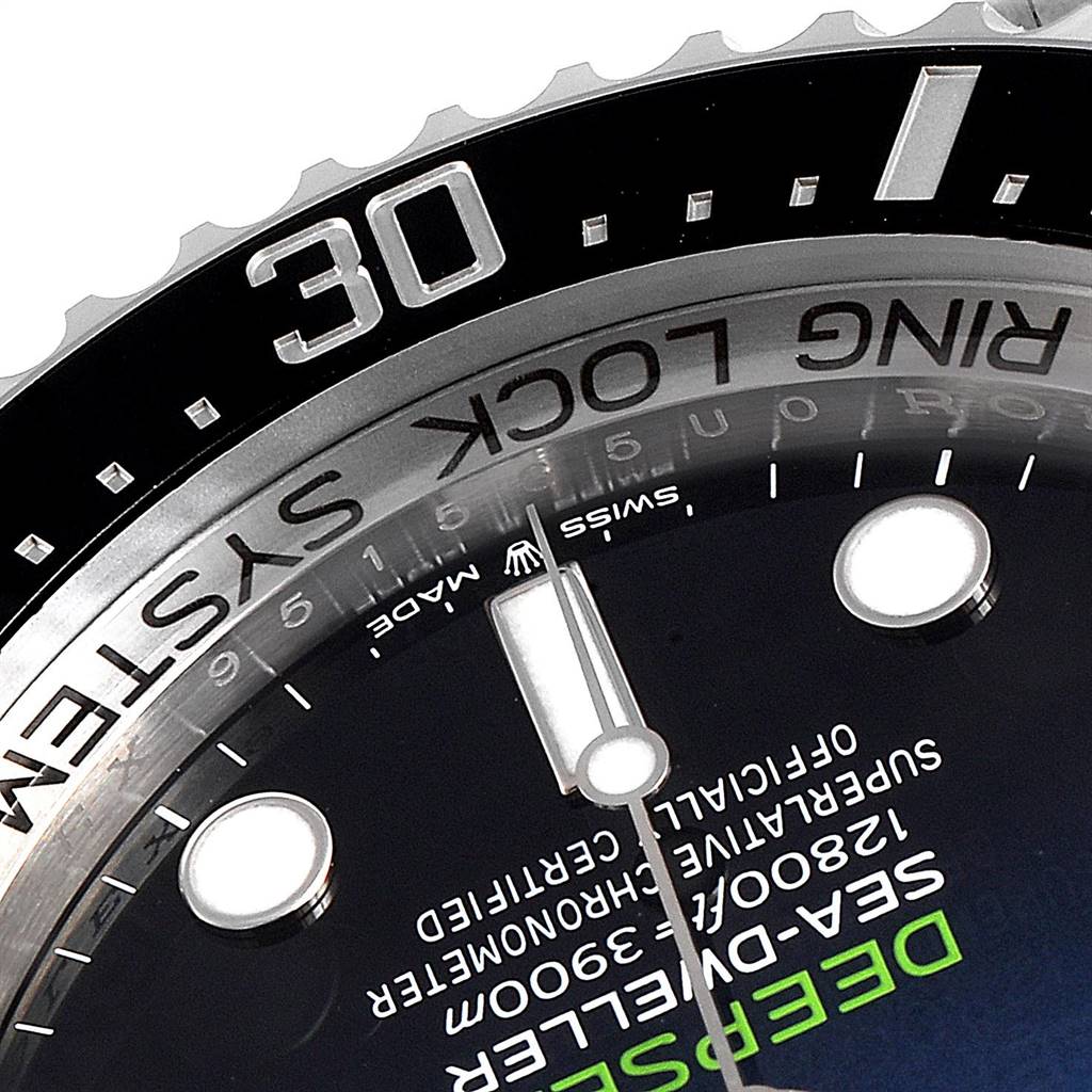 This close-up image of the Rolex Sea-Dweller 126660 Men
s Stainless Steel Blue Dial 126660 Men
s Stainless Steel Blue Dial watch shows the bezel and parts of the dial, including the "RING LOCK SYSTEM" engraving.