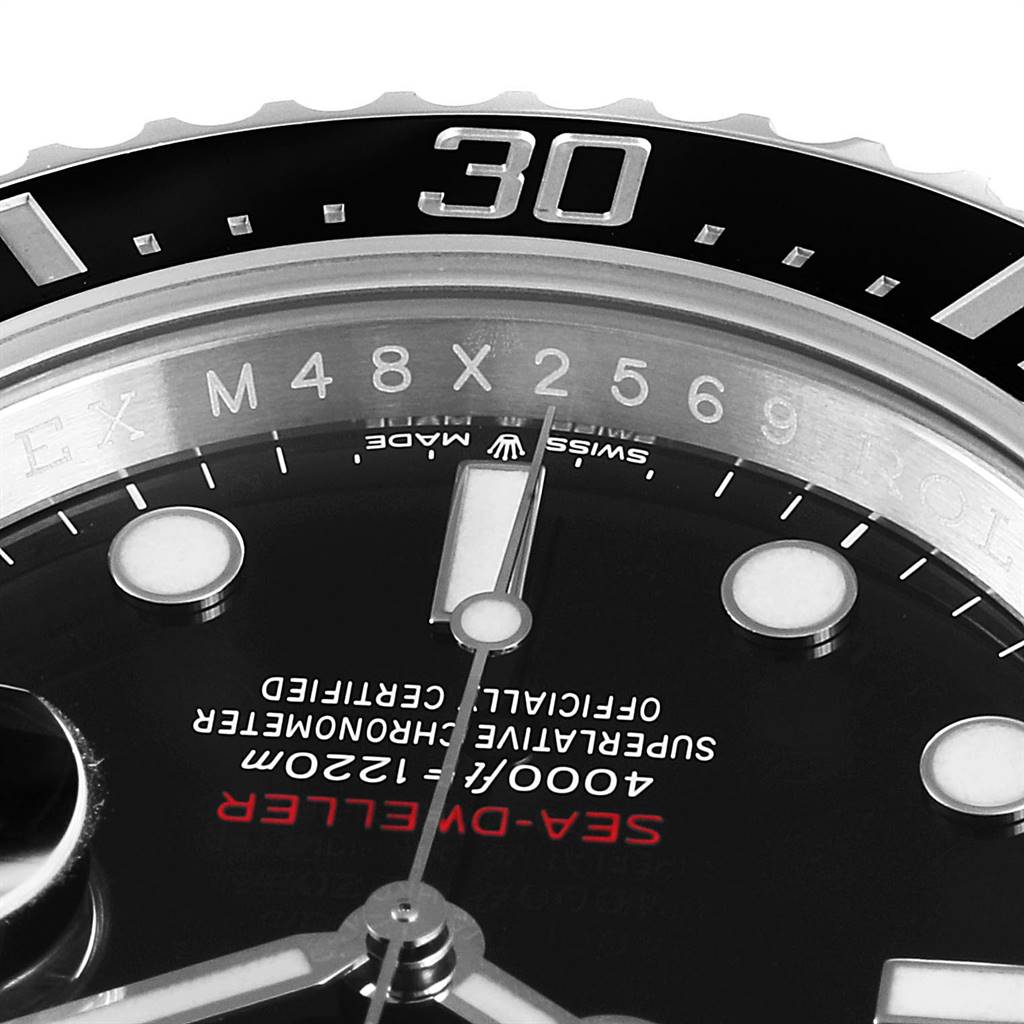 This close-up image of the Rolex Sea-Dweller 126600 Men
s Stainless Steel Black Dial 126600 Men
s Stainless Steel Black Dial watch shows the bezel, part of the dial, and the watch hands.