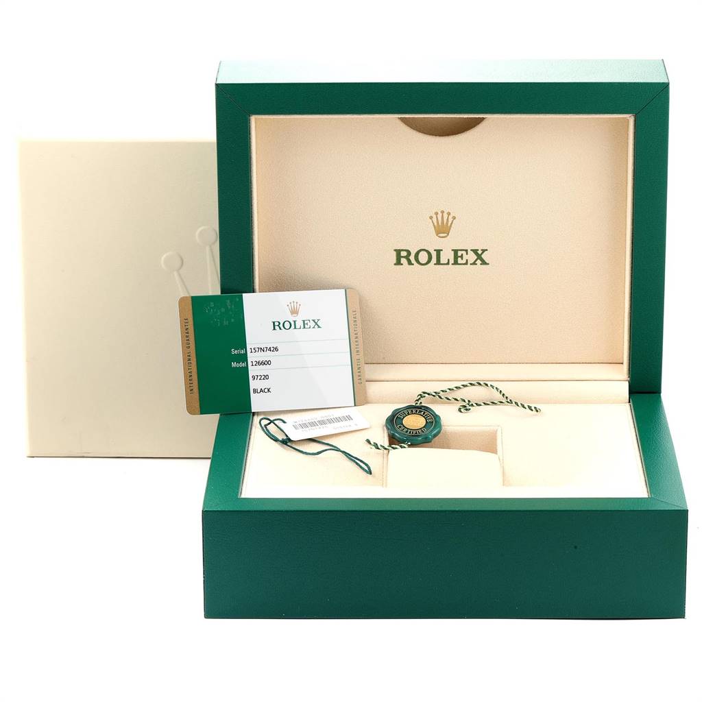 This image shows the open box, tag, and warranty card for a Rolex Sea-Dweller 126600 Men
s Stainless Steel Black Dial 126600 Men
s Stainless Steel Black Dial watch model.