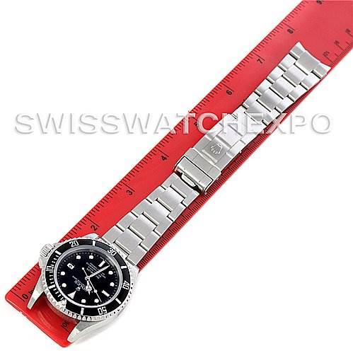 The image shows a Rolex Sea-Dweller 16600 Men's Stainless Steel Black Dial 16600 Men's Stainless Steel Black Dial watch laid flat on a red ruler, displaying the face, bezel, and full metal bracelet.