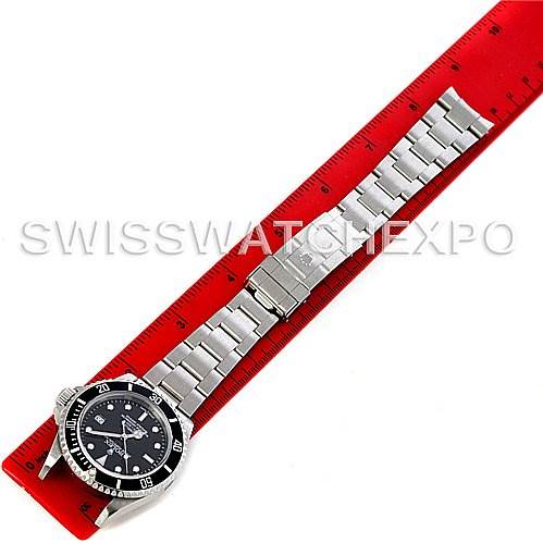 The image shows the front view of a Rolex Sea-Dweller 16600 Men's Stainless Steel Black Dial 16600 Men's Stainless Steel Black Dial watch, including the face, bezel, and metal bracelet, laid on a red ruler.