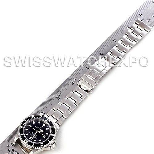 The image shows a side angle of a Rolex Sea-Dweller 16600 Men's Stainless Steel Black Dial 16600 Men's Stainless Steel Black Dial watch featuring its face, bezel, and bracelet next to a ruler.
