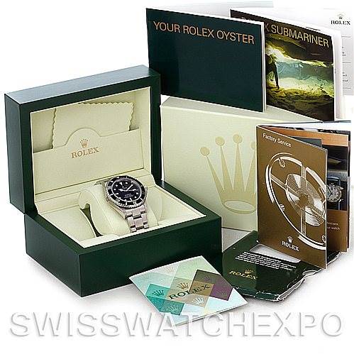 The image shows a Sea-Dweller model by Rolex in its box, along with various booklets and warranty cards from an overhead angle.