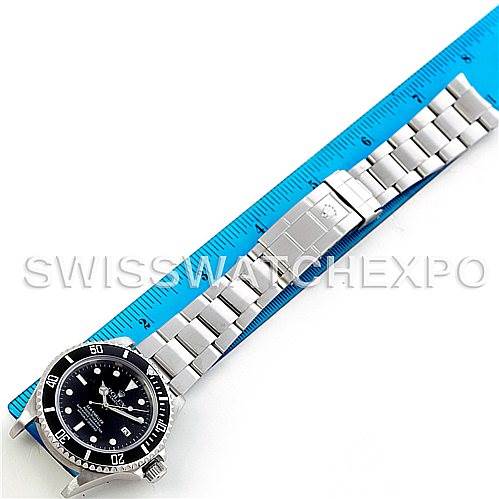 The image shows a Rolex Sea-Dweller 16600 Men's Stainless Steel Black Dial 16600 Men's Stainless Steel Black Dial watch laid flat with a blue ruler measuring its length, displaying the face, bezel, and metal bracelet.