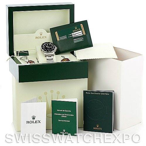 The image shows a Rolex Sea-Dweller 116660 Men
s Stainless Steel Black Dial 116660 Men
s Stainless Steel Black Dial watch in its box along with warranty cards and manuals.